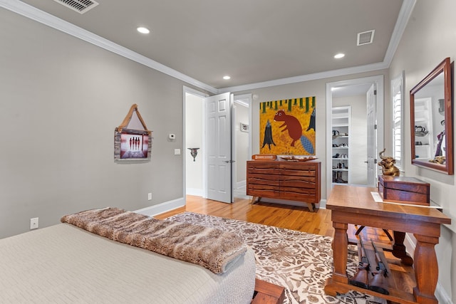 bedroom with hardwood / wood-style flooring and crown molding