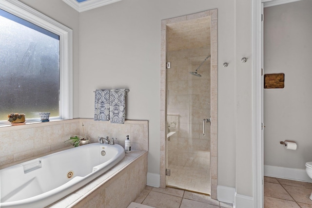 bathroom with toilet, plenty of natural light, shower with separate bathtub, and tile patterned flooring