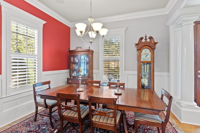 dining area featuring a notable chandelier, plenty of natural light, and ornate columns