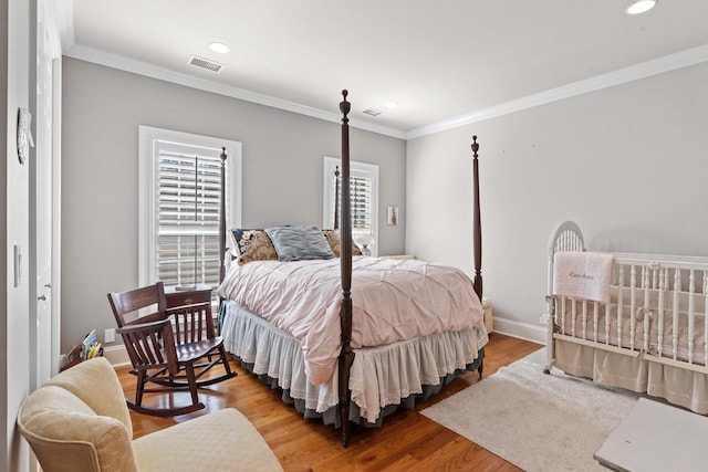 bedroom featuring crown molding and hardwood / wood-style floors