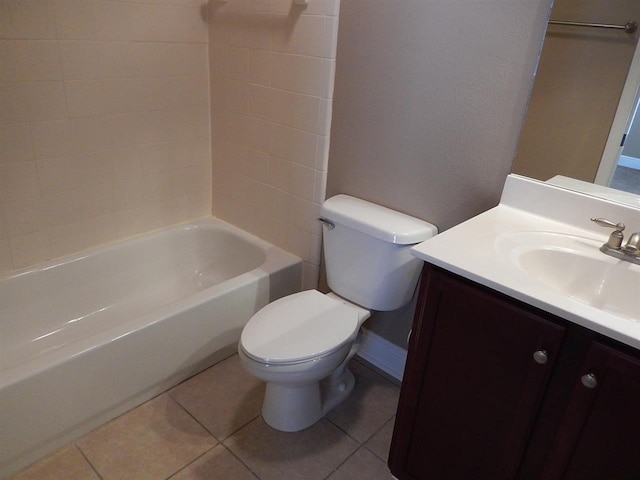 full bathroom featuring washtub / shower combination, tile patterned floors, toilet, and vanity