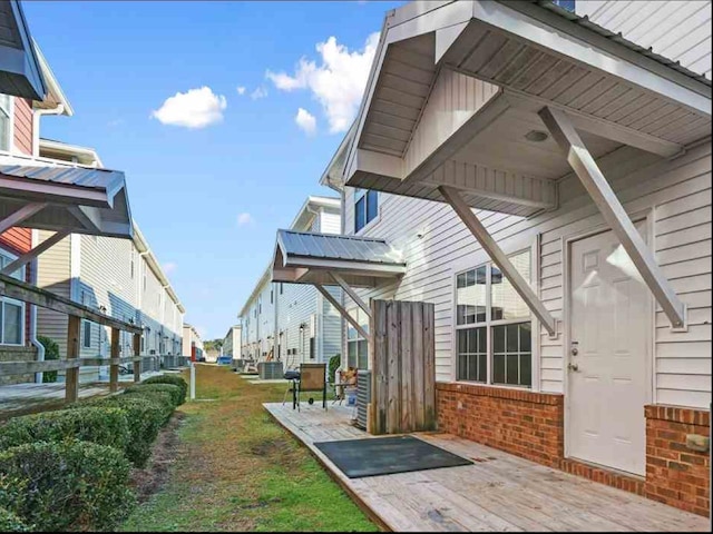 view of side of home featuring cooling unit and a deck