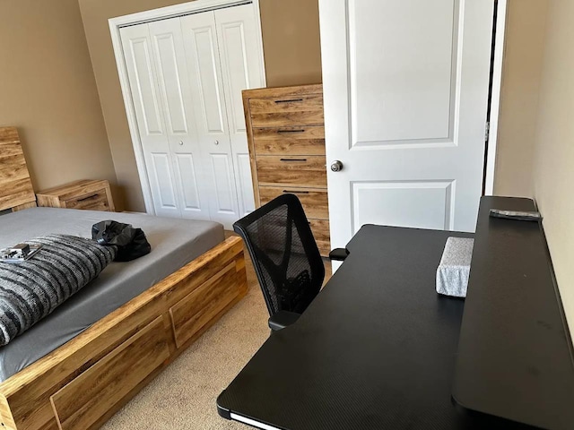 bedroom with light colored carpet and a closet