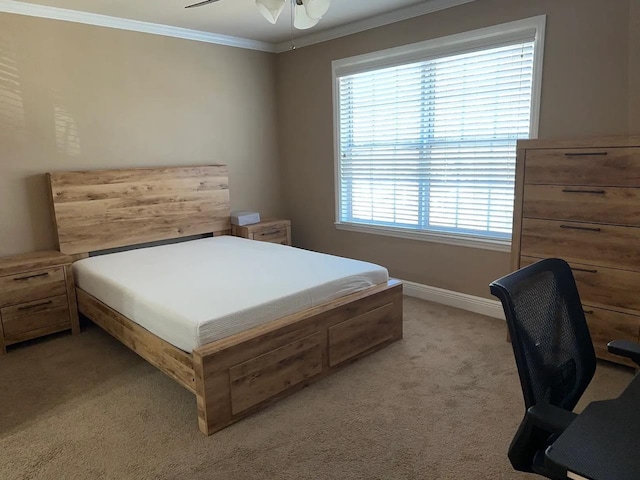 bedroom featuring crown molding, light colored carpet, and ceiling fan