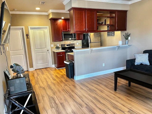 kitchen featuring crown molding, light hardwood / wood-style floors, decorative backsplash, and appliances with stainless steel finishes