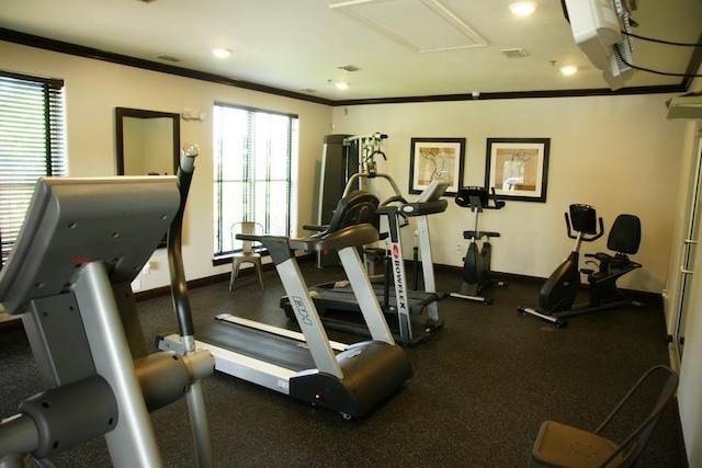 workout area featuring crown molding