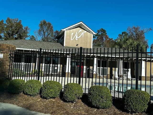 view of gate featuring a community pool