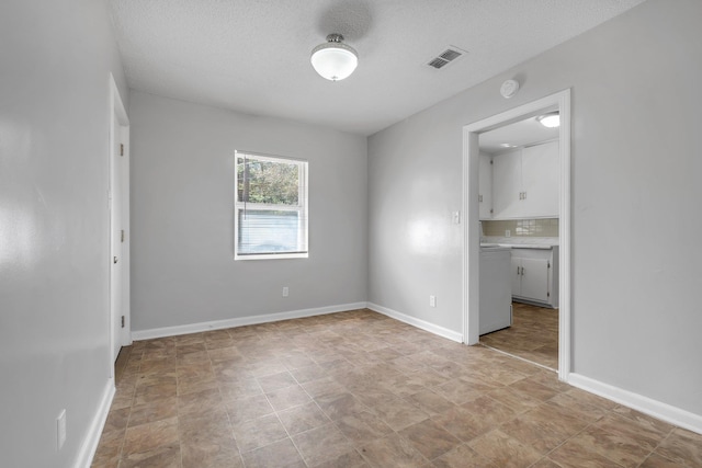 unfurnished bedroom featuring a textured ceiling, visible vents, and baseboards