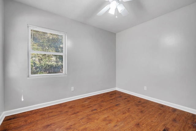 unfurnished room with ceiling fan, baseboards, and wood finished floors