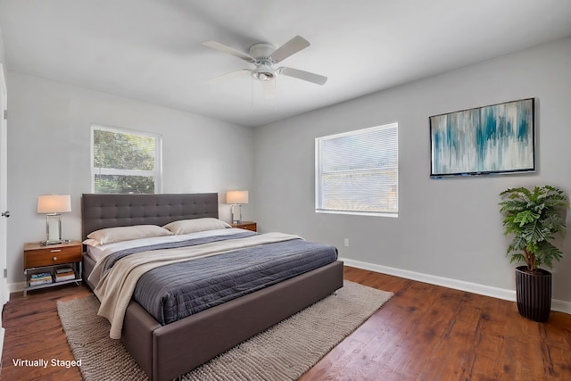 bedroom featuring wood finished floors, a ceiling fan, and baseboards