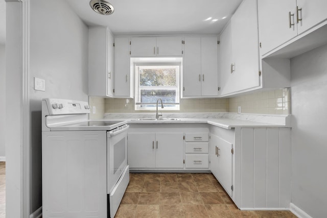 kitchen featuring white electric stove, a sink, visible vents, light countertops, and tasteful backsplash