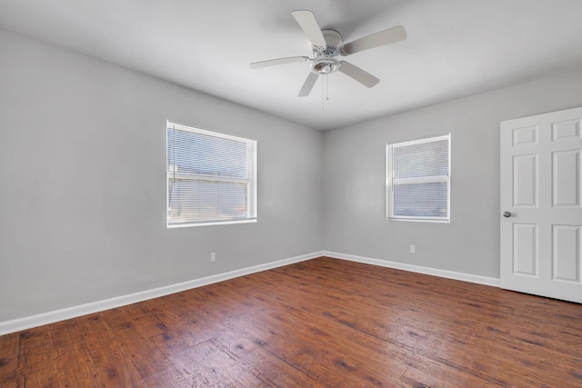 empty room featuring a ceiling fan, baseboards, and wood finished floors