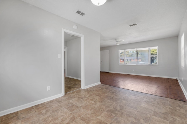 unfurnished room with visible vents and baseboards