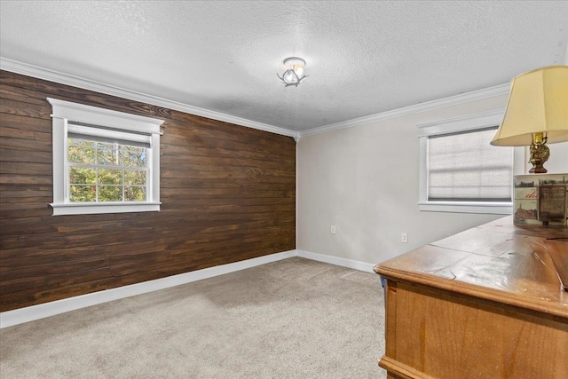 unfurnished office featuring wooden walls, dark colored carpet, and ornamental molding