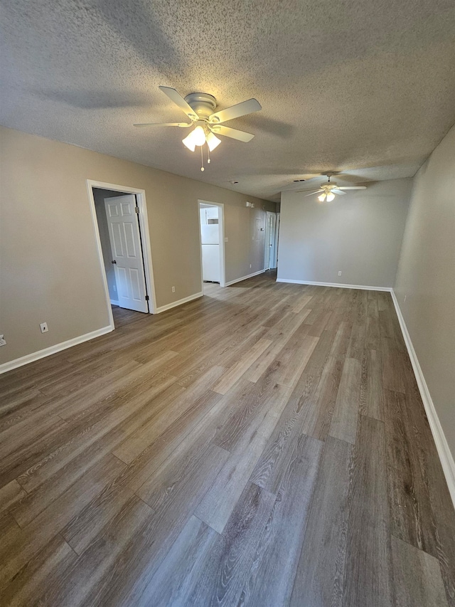 spare room with hardwood / wood-style floors, a textured ceiling, and ceiling fan