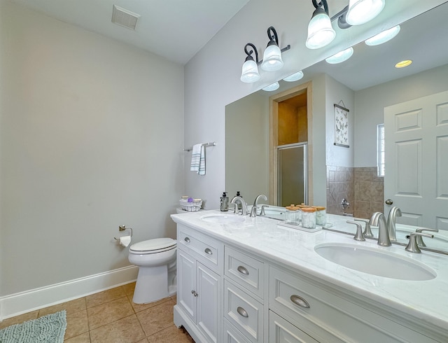 bathroom featuring tile patterned flooring, toilet, an enclosed shower, and vanity