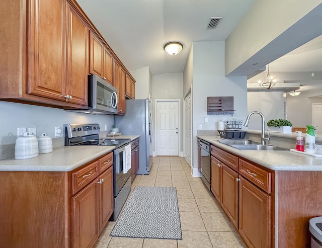 kitchen featuring a chandelier, stainless steel appliances, light tile patterned flooring, and sink