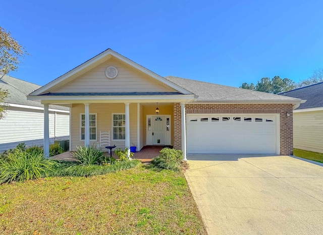 view of front of house with a porch, a garage, and a front lawn