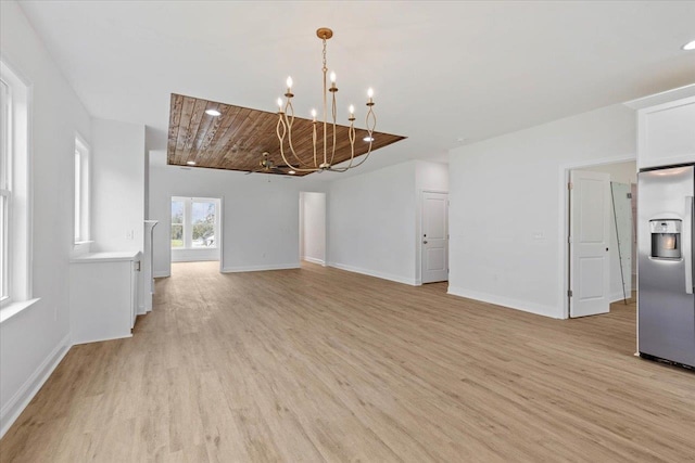 interior space with light wood-type flooring, a chandelier, and wooden ceiling