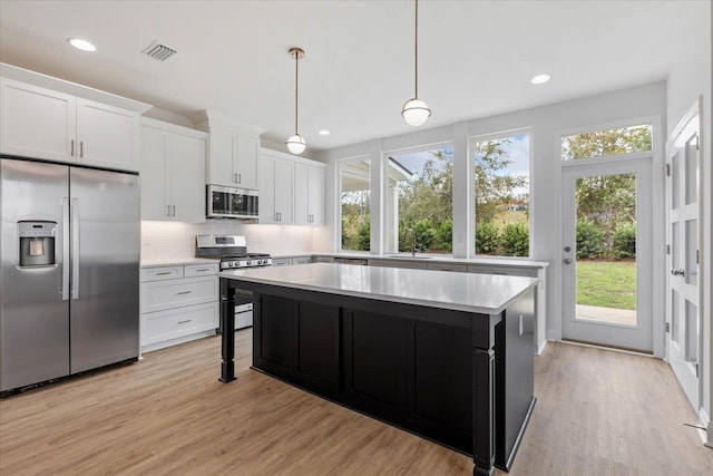 kitchen featuring white cabinetry, a wealth of natural light, appliances with stainless steel finishes, and light hardwood / wood-style floors