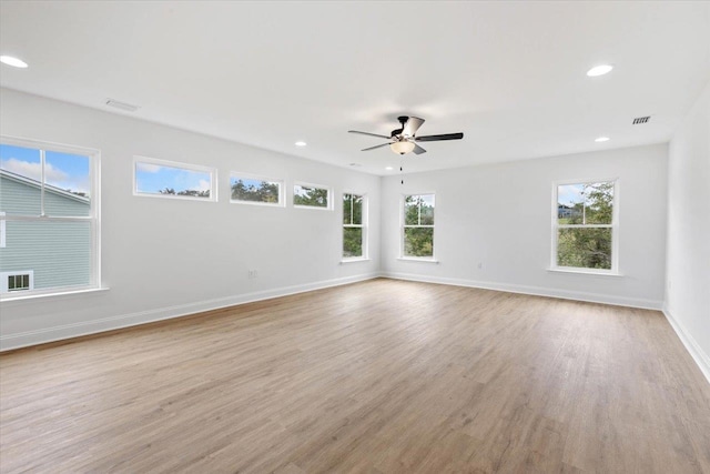 empty room with light hardwood / wood-style floors and ceiling fan