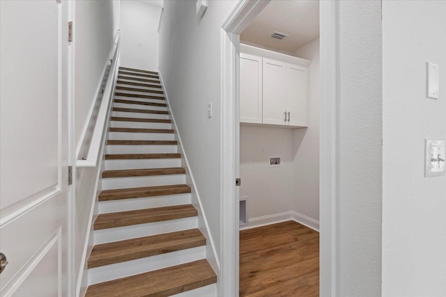 staircase featuring wood-type flooring