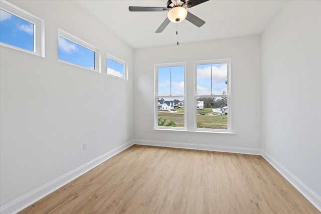 empty room with light hardwood / wood-style floors and ceiling fan