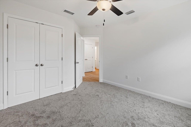 unfurnished bedroom featuring a closet, light carpet, and ceiling fan