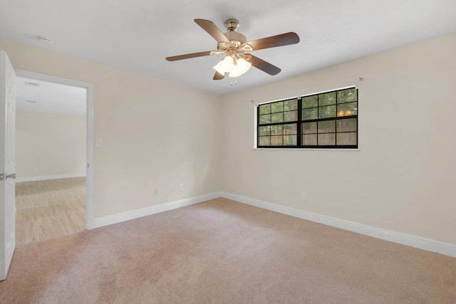 carpeted spare room with ceiling fan