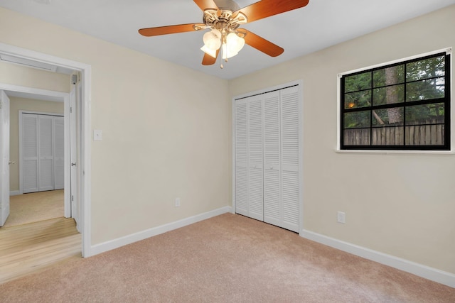 unfurnished bedroom featuring a closet, light carpet, and ceiling fan