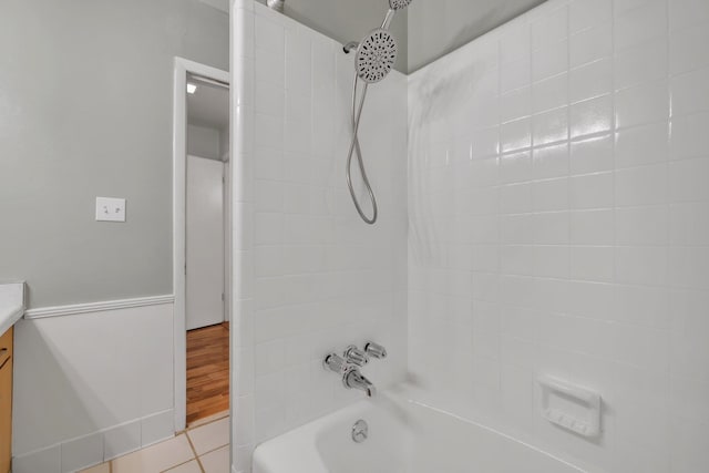 bathroom with tiled shower / bath, vanity, and tile patterned floors