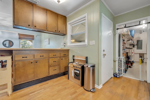 kitchen featuring ornamental molding, electric panel, and light hardwood / wood-style flooring