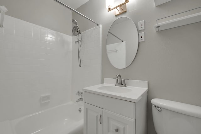 full bathroom with toilet, tiled shower / bath combo, and vanity