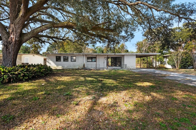 ranch-style home with a front lawn and a carport