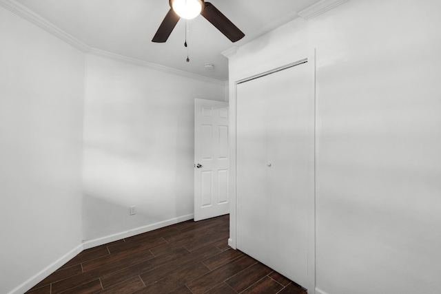 unfurnished bedroom featuring crown molding, ceiling fan, and a closet