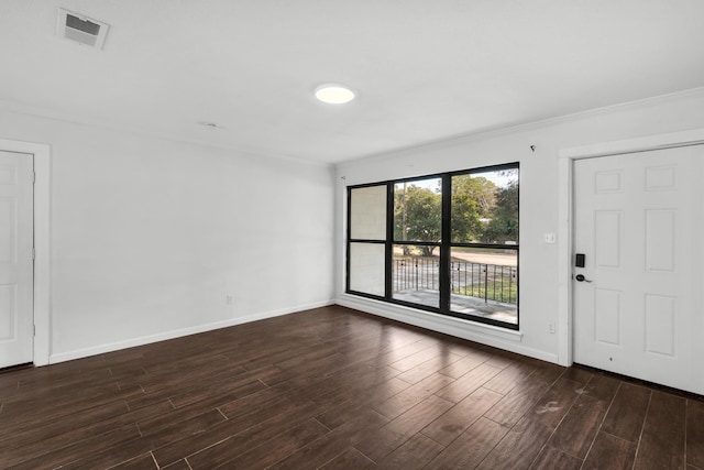 empty room with ornamental molding and dark hardwood / wood-style floors