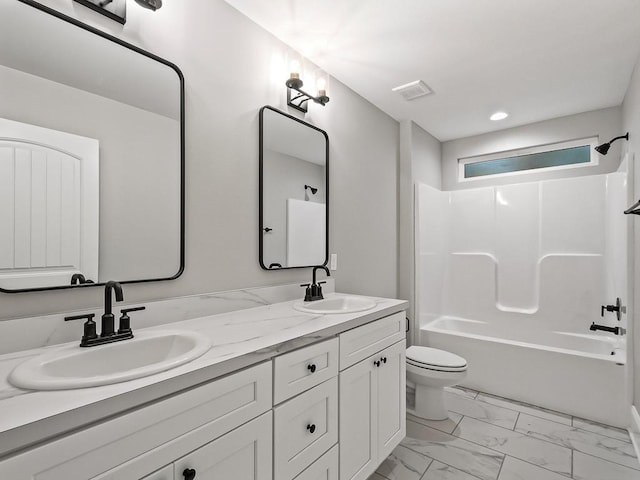bathroom featuring a sink, toilet, double vanity, and marble finish floor