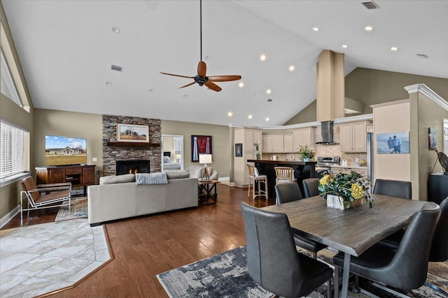 7087 Valhalla Ranch Dr, Perry, FL 32348 - dining room with high vaulted ceiling, a fireplace, wood finished floors, and a ceiling fan
