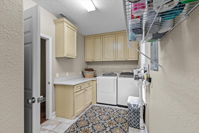 7087 Valhalla Ranch Dr, Perry, FL 32348 - laundry area featuring cabinet space, washing machine and clothes dryer, a textured wall, a textured ceiling, and light tile patterned flooring