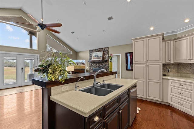 7087 Valhalla Ranch Dr, Perry, FL 32348 - kitchen with dark wood-style flooring, high vaulted ceiling, an island with sink, stainless steel dishwasher, and a ceiling fan