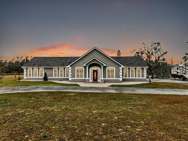 7087 Valhalla Ranch Dr, Perry, FL 32348 - single story home with a yard, stucco siding, and a chimney