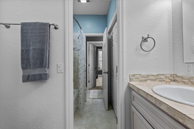 7087 Valhalla Ranch Dr, Perry, FL 32348 - full bath with a textured wall, vanity, tile patterned floors, and shower / tub combo with curtain