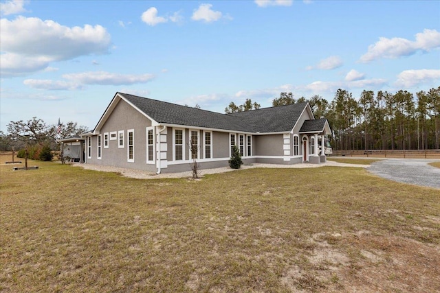 7087 Valhalla Ranch Dr, Perry, FL 32348 - view of side of property featuring stucco siding and a yard