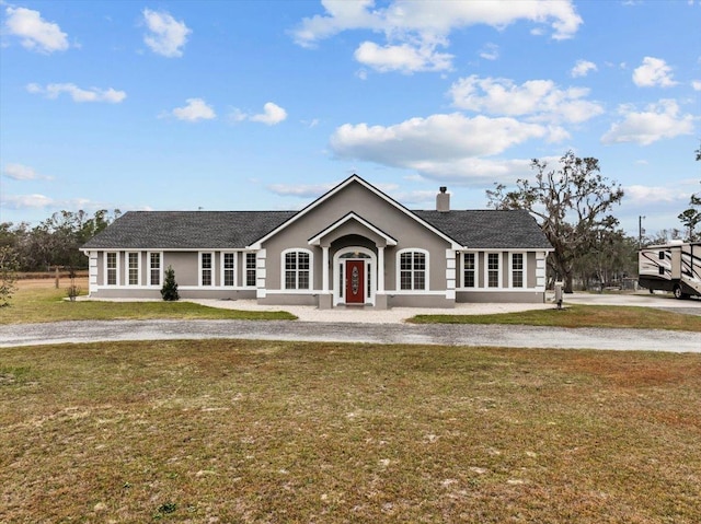 7087 Valhalla Ranch Dr, Perry, FL 32348 - view of front of property with stucco siding, a front yard, and a chimney