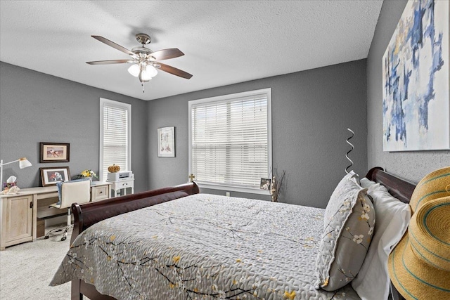 7087 Valhalla Ranch Dr, Perry, FL 32348 - bedroom featuring a textured wall, light colored carpet, a textured ceiling, and a ceiling fan