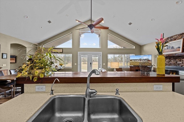 7087 Valhalla Ranch Dr, Perry, FL 32348 - kitchen featuring a ceiling fan, light stone countertops, french doors, high vaulted ceiling, and open floor plan
