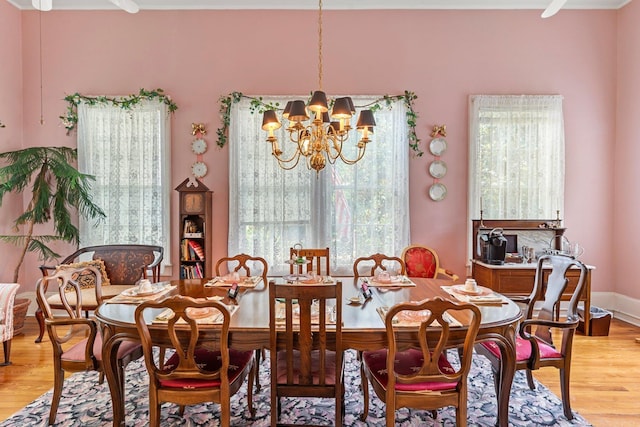 dining space with a chandelier and light wood-style flooring