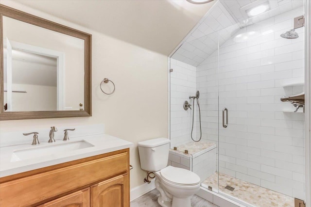 bathroom featuring vanity, toilet, an enclosed shower, and lofted ceiling