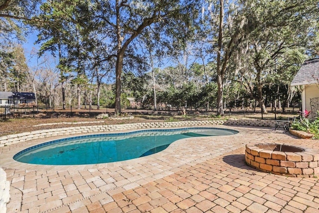 view of pool with a patio area and a fire pit