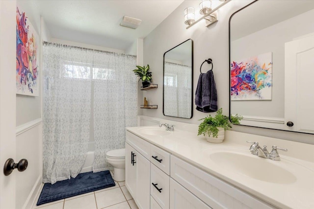 full bathroom featuring toilet, vanity, tile patterned floors, and washtub / shower combination